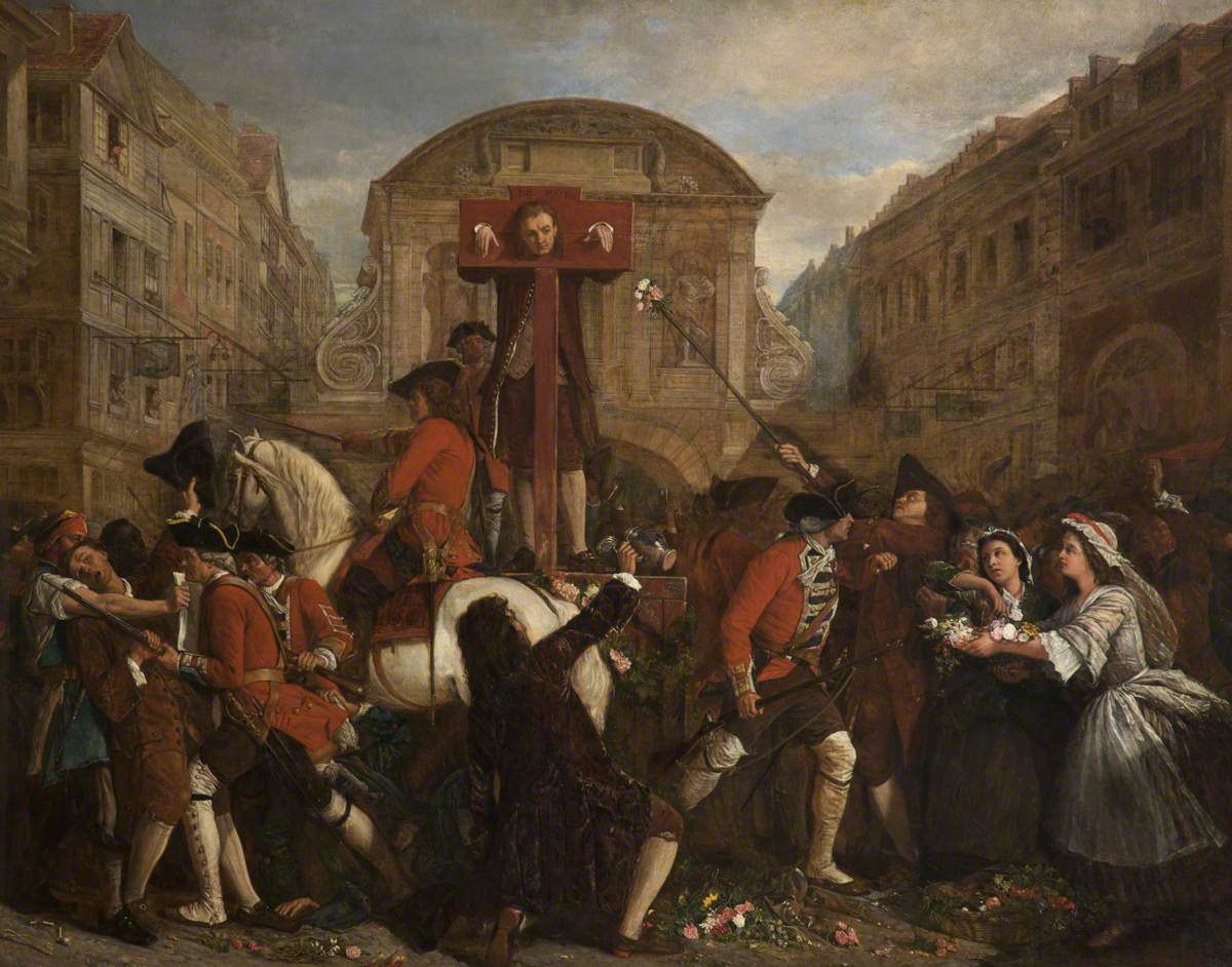 A medieval illustration of a man locked in a wooden pillory in a town while people look on.